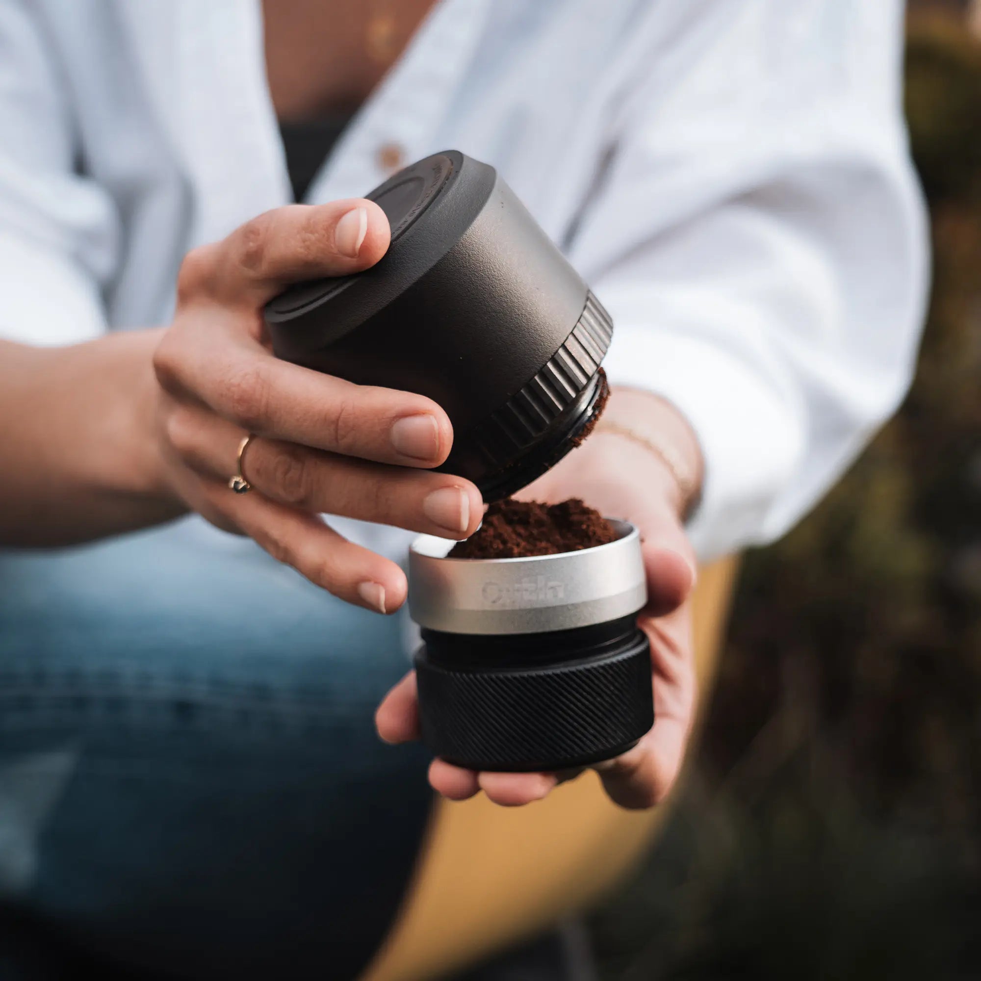 Outin Fino Portable Electric Coffee Grinder, person holding it